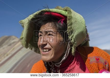Vinicunca, Cusipata, Peru - June 08, 2017: Peruvian Andean Woman Wearing Traditional Colorful Clothi
