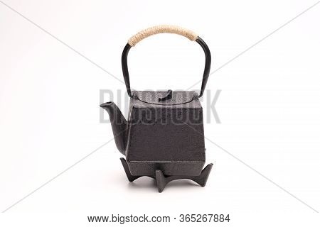 Black Metal Cast-iron Traditional Teapot On White Background.