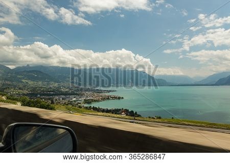 View Of The Amazing Lake Geneva From Highway. Country Houses Surrounded By Green Vineyards. Area Nea