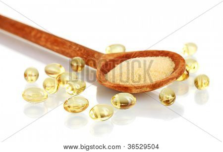 Gelatin in a wooden spoon on white background close-up