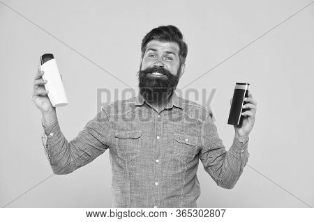 Bath Soap. Bath Cosmetics Review. Man Bearded Hipster Hold Plastic Bottles. Hair Care. Skin Lotion. 