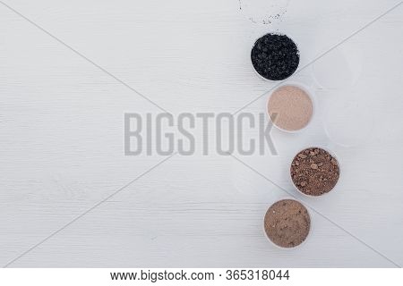 Samples Of Different Types Of Soil In Banks On The Table. Soil Science Concept.
