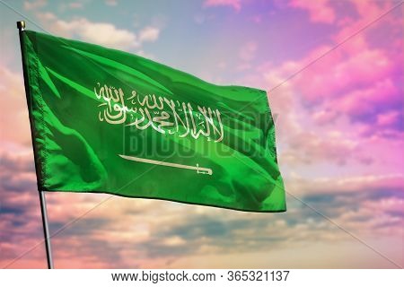 Fluttering Saudi Arabia Flag On Colorful Cloudy Sky Background. Saudi Arabia Prospering Concept.