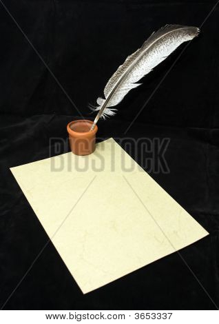 Ink Bottle And A Quill On An Old Paper