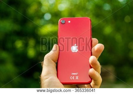 Paris, France - Apr 24, 2020: Man Hand Showing Rear Logotype On New Budget Iphone Se By Apple Comput