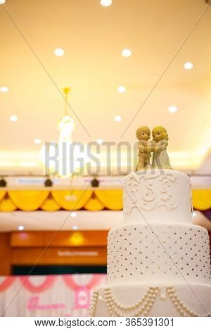 Figurines Of The Bride And Groom On A Wedding Cake Corny Wedding Cake That Symbolizes The Commitment