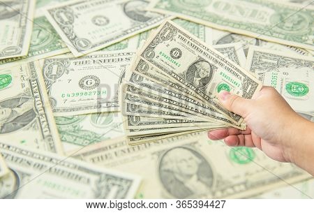 Hand Hold Many Dollar Banknotes And Another One Act Receive That Money With Dollar Background. Corru