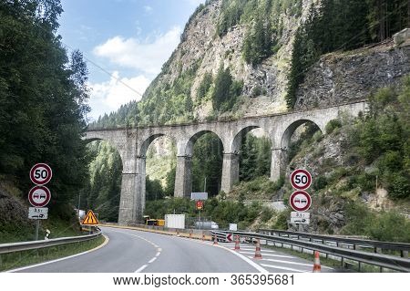A Road And An Old Train Bridge In Chamonix, France. Perfect Moment In Alpine Highlands. Mont-blanc M