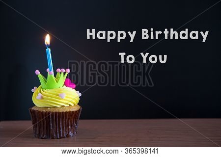 Cup Cake And Happy Birthday To You Text On Chalkboard Background..birthday Cupcake With A Single Blu