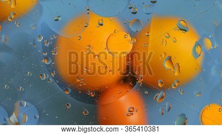 Reflection Of Yellow And Orange Cicles On The Oily Water. Abstract Effect, Can Be Used For Any Purpo