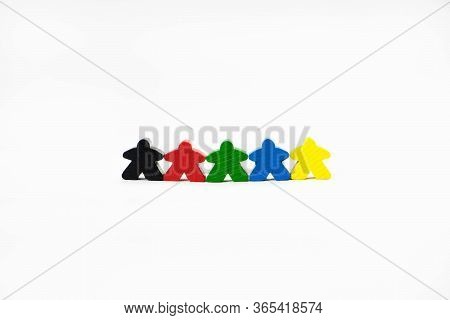 People For Board Games Are On A White Background. They Are Of Different Colors. Wooden Toy People Sy