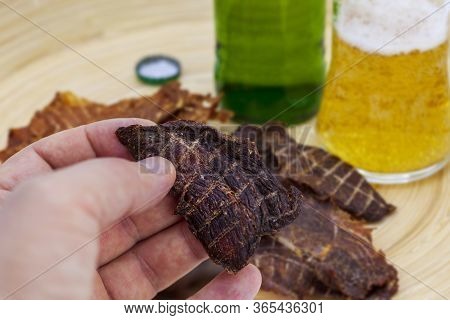Dry Jerky Jerky For Beer. Beef Jerky In A Male Hand