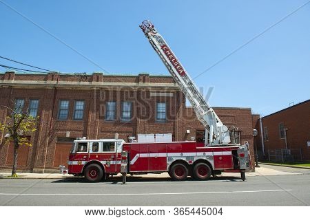 Chelsea, Ma, Usa - May 9, 2019: Chelsea Fire Truck Ladder 3 Raised The Ladder In Downtown Chelsea, M