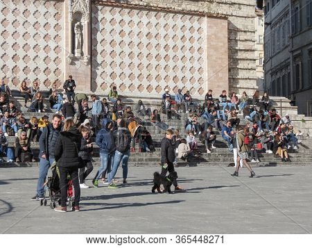 Perugia, Italy - Circa April 2019: People Sitting On The Stariway Of The Cathedral In A Sunny Day