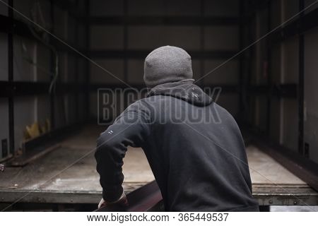 Loaders Are Loading Metal Into A Lorry. Transportation Of Heavy Industrial Products. Men Do Their Jo