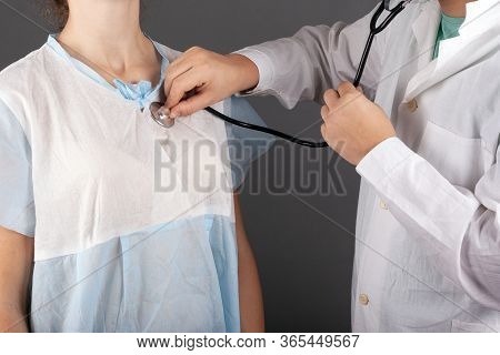 Doctor Listens To The Patient Heartbeat With A Statoscope. Medical Ambulance Examination Treatment I