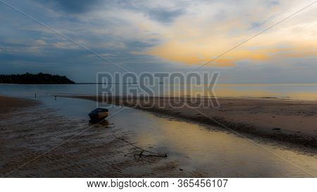 Dinghy Sitting In Tidal Pool At Beach At Low Tide During Sunset In Pythiu On The Gulf Of Thailand Wi