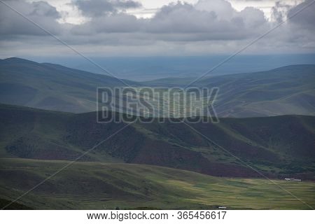 Overlooking The Valley Of Qilian Mountains Prairie Covered By Dark Clouds