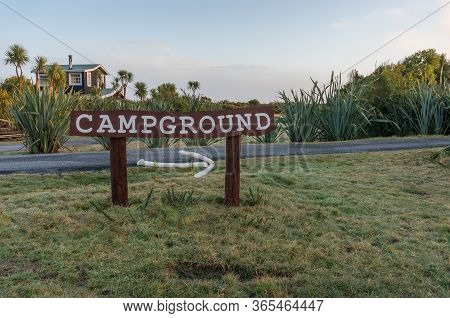 Okarito, New Zealand - July 29, 2015: Sign To Okarito Campground In Countryside New Zealand, Tourist