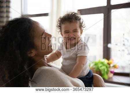 Young Biracial Mom Play With Smiling Little Baby Girl