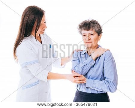 Doctor Is Giving Help To Woman Who Suffers From Crick In The Back - Isolated On White.