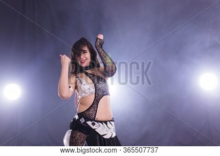 Girl Dancing Belly Dance, Fusion Or Tribal. A Woman In A Beautiful Costume Demonstrates Charming And