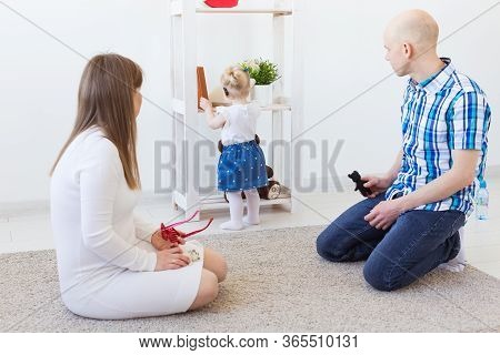 Hearing Aid In Baby Girls Ear. Toddler Child Wearing A Hearing Aid At Home. Disabled Child, Disabili