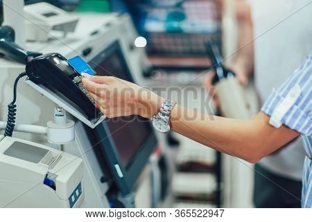 Couple With Bank Card Buying Food At Grocery Store Or Supermarket Self-checkout