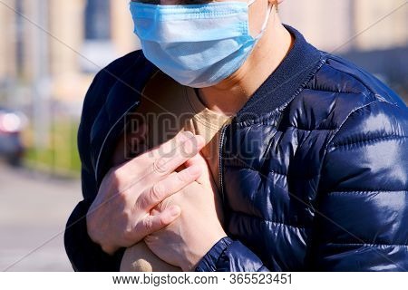 A Masked Woman In The Street Felt A Twinge Of Pain In Her Chest. Fit Of Coughing. Holding On With Bo