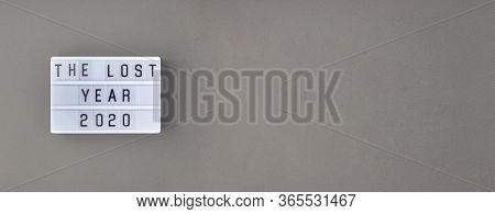 Falling Growth In Business, Composition With Lightbox With The Lost Year 2020 Slogan On Grey Paper B