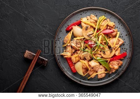 Thai Ginger Chicken Or Gai Pad King In Dark Plate At Black Slate Backdrop. Gai Pad King Is Thailand