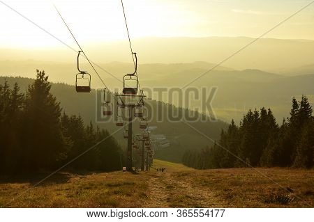 Ski Chair Lift In The Mountains At Sunset