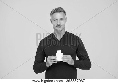Body Odor Care. Handsome Man Hold Lotion Or Bodywash Bottle. Presenting Personal Hygiene Care Produc