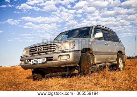 Novyy Urengoy, Russia - May 10, 2020: Grey 4x4 Vehicle Toyota Land Cruiser 100 At The Dry Grassland.