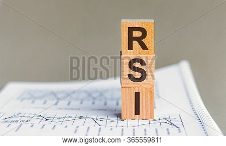 Rsi - Relative Strength Index Acronym Concept On Cubes And Diagrams On A Gray Background.