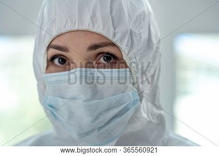 Close-up Of Female Medical Worker In Protective Clothing And Medical Mask