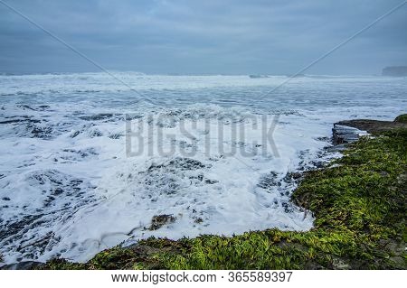 Foam And Waves Of The Ocean In Cloudy Weather.
