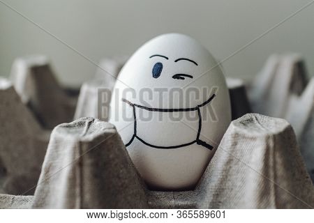 White Egg In A Cardboard Stand. Funny Emotions, Facial Expressions.