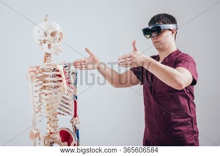Doctor Uses Augmented Reality Goggles To Exam Human Skeleton.
