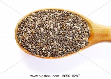 Black Chia Seeds In A Wooden Spoon Close-up. Macrophotography Of Chia. Health Food. Good Nutrition. 