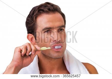 Cutout of attractive man looking in the mirror while flossing hsi teeth