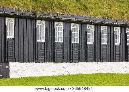 Picturesque Green Roof  Wooden Faroese Black Chapel Facade. Faroe Islands