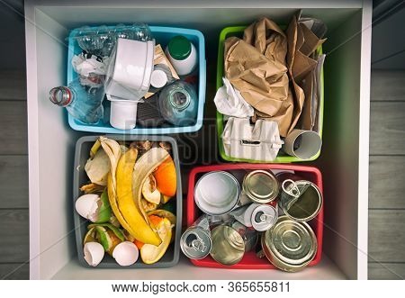 The four different container for sorting garbage. For plastic, paper, metal and organic waste