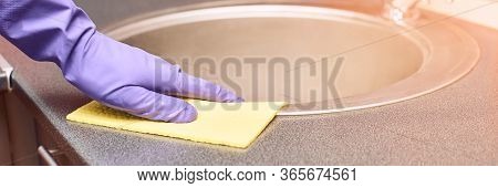 Hand In Protective Glove Clean Kitchen Sink. House Cleaning With Rag. Washing Worktop. Disinfect Ras