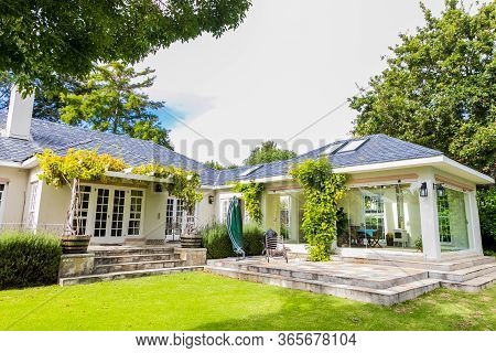 Patio Terrace Of Upmarket Wealthy Suburban Mansion House With Landscaped Garden