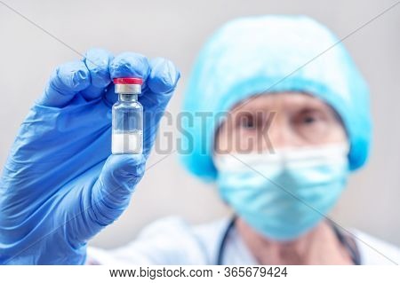 Doctor, Nurse, Scientist Hand In Blue Gloves Holding Injection Vial. Flu, Measles, Coronavirus, Covi