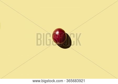 Red Tomato On A Yellow Background View From Above