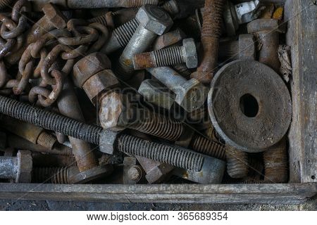 Old And Rusty Screw On A Wooden Box In A Car Workshop