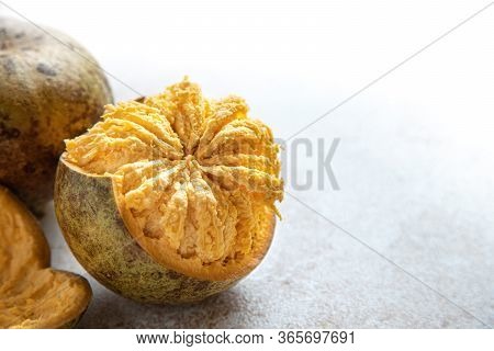 Exotic Indian Bel Fruit Or Wooden Apple. Bel Fruit Slices On Wooden Rustic Background. Natural Detox