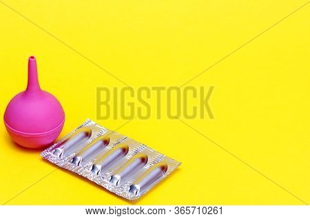 Medical New Enema. Enema In Medicine. Medical Suppositories In A Silver Blister Pack And A Pink Rubb